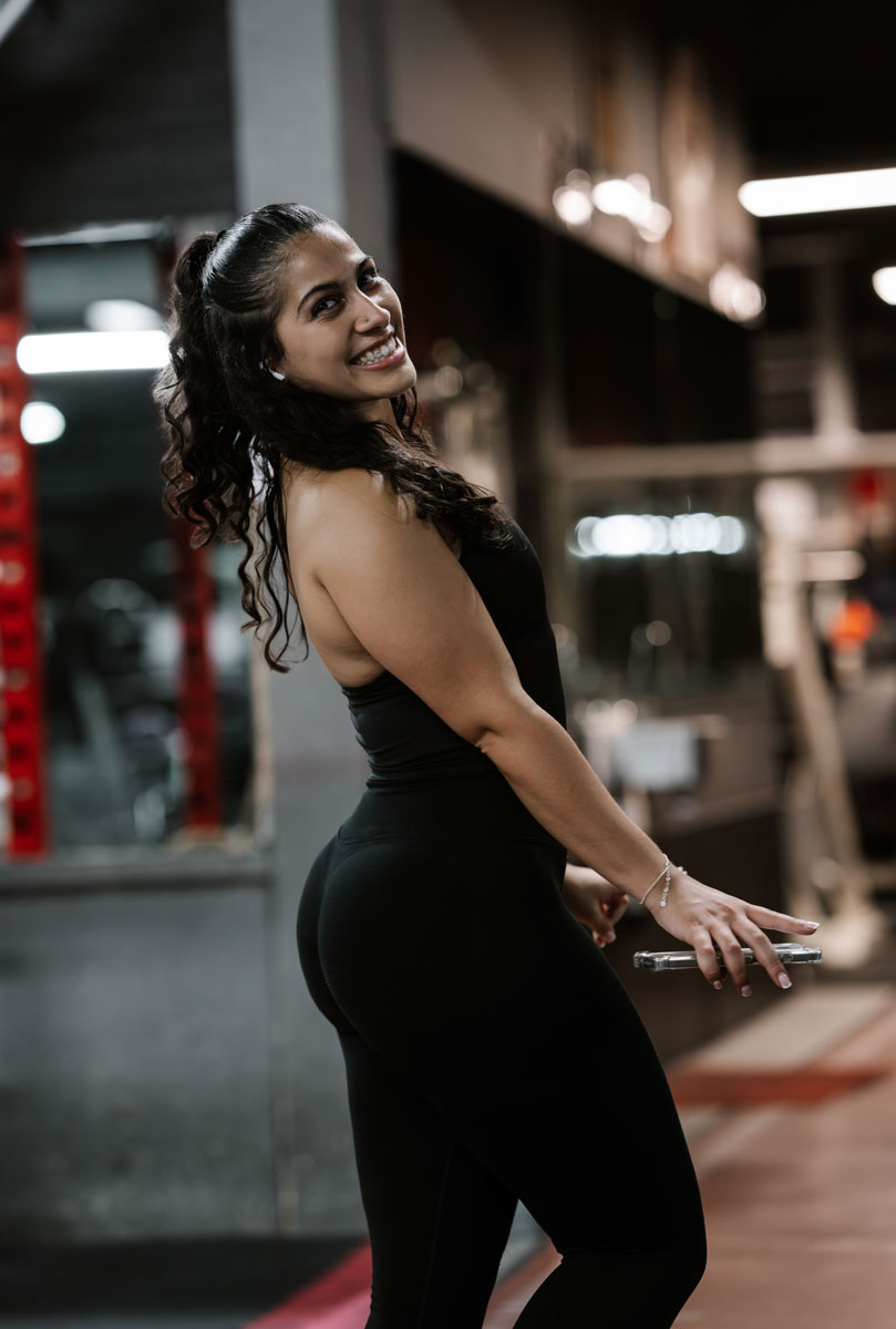 The coach is posing at the gym.