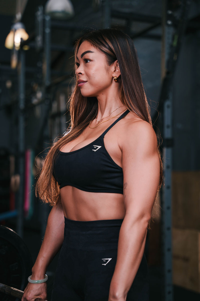 The coach is posing while wearing black clothing.