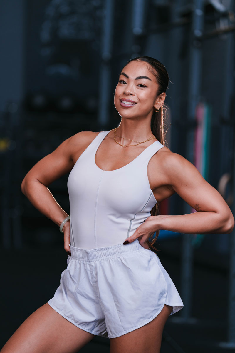 The coach is posing while wearing white clothing.