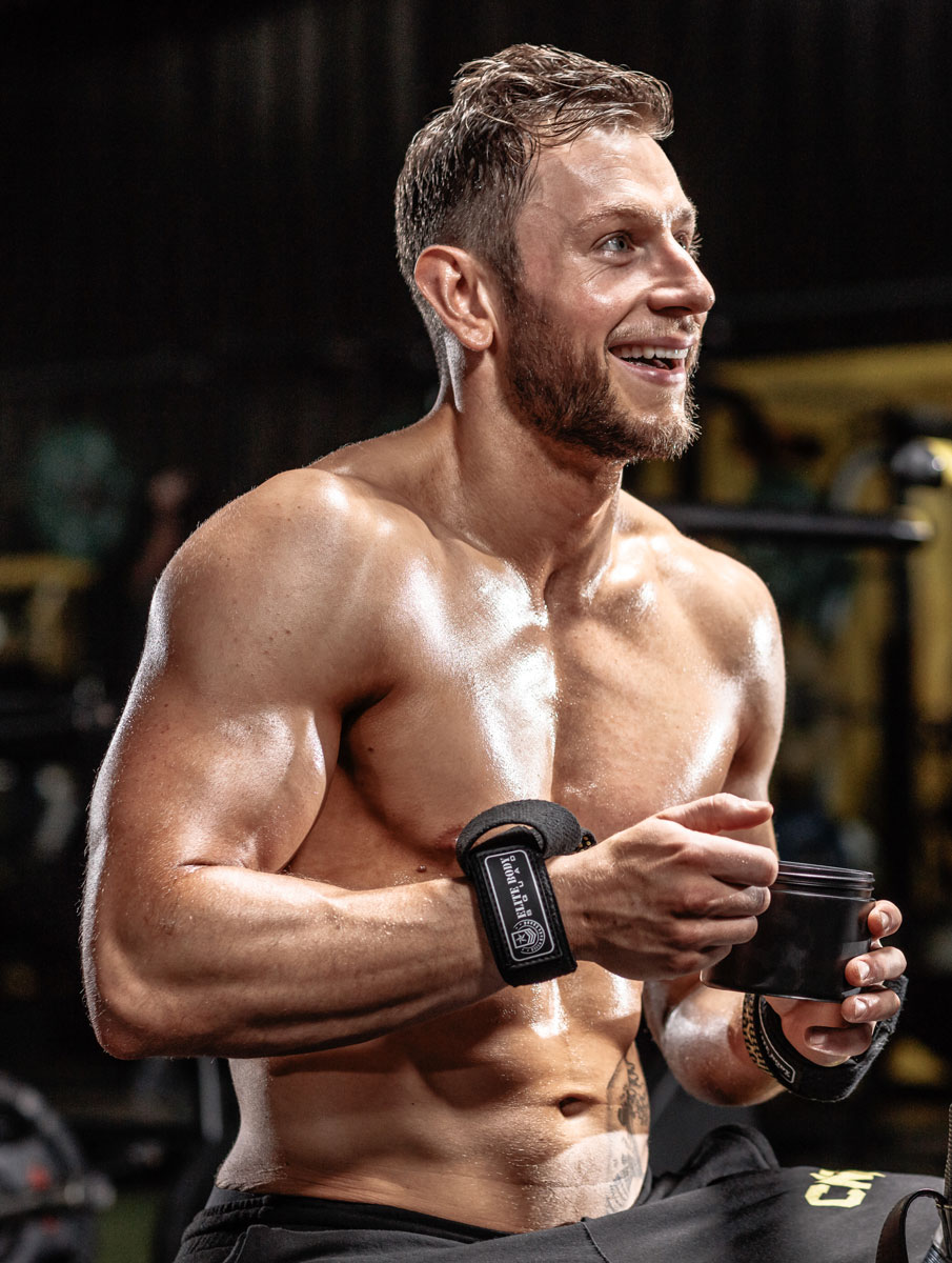 The coach is smiling at the gym.
