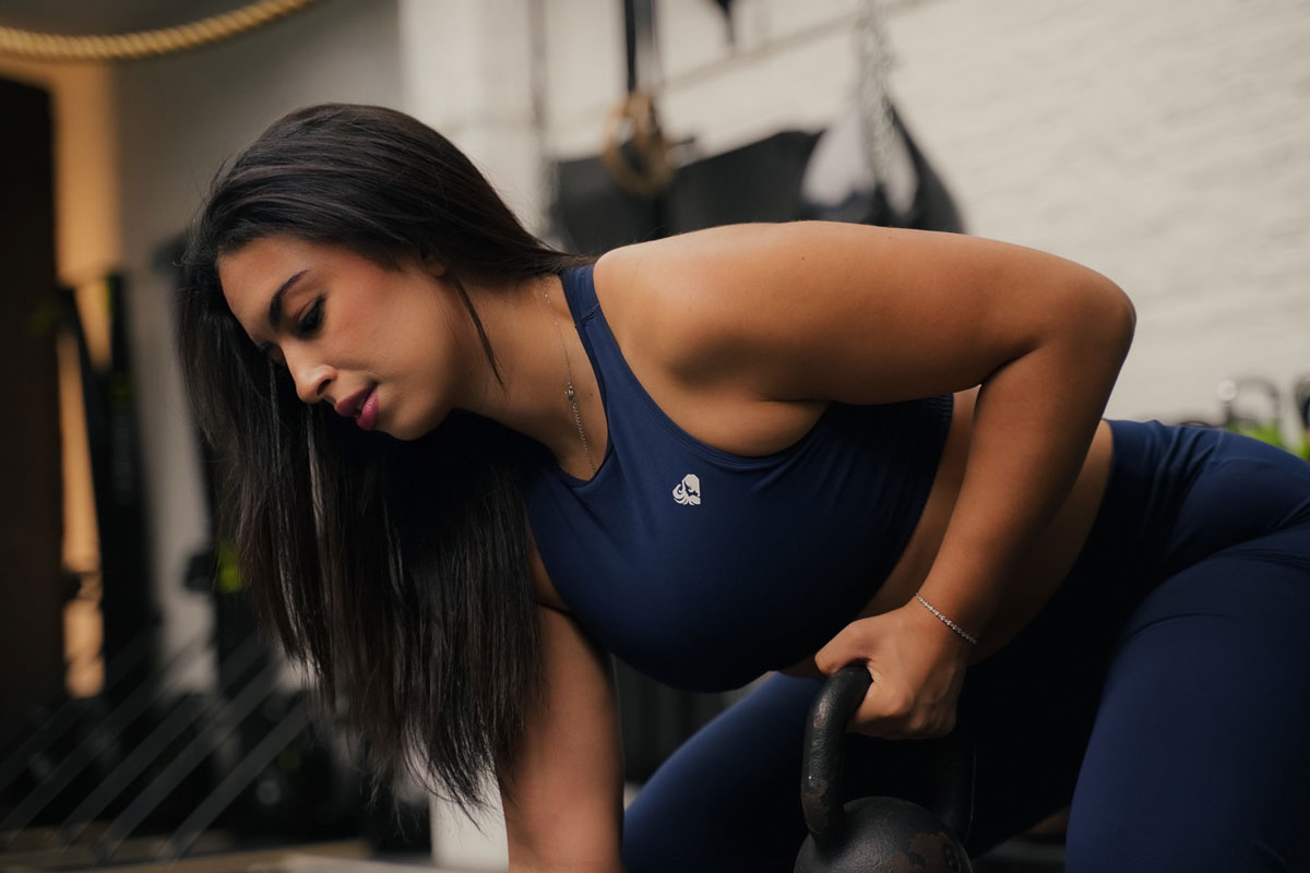 The coach is holding a kettlebell